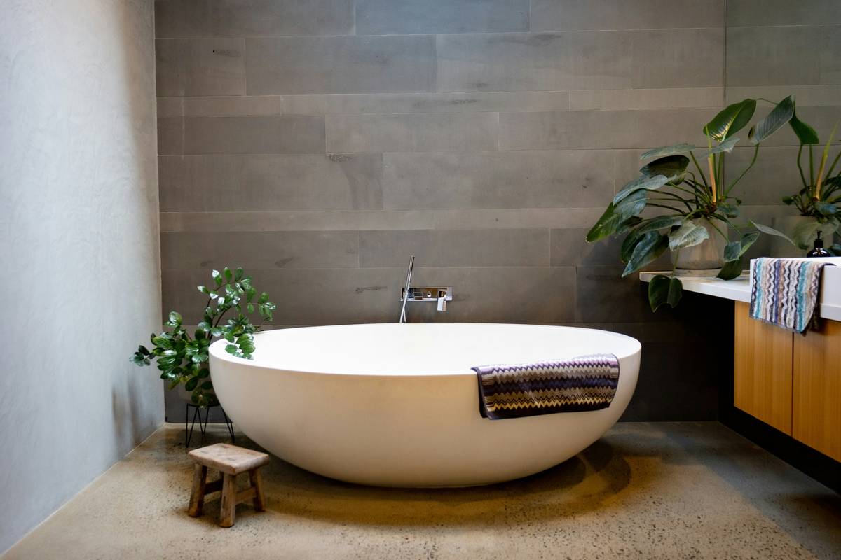 bathroom accessories list featuring biodegradable toilet paper, bamboo toothbrushes, and glass soap dispensers on a reclaimed wood shelf